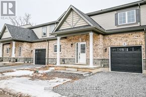 Fort Erie (Crescent Park) house for rent - A large, two-story house with a garage door and a driveway.