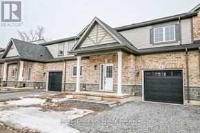 Fort Erie (Crescent Park) house for rent - A large house with a black garage door is shown.