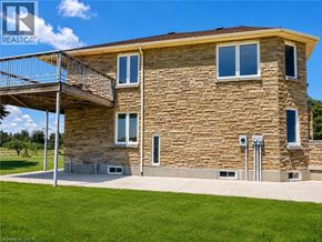 Hamilton apartment for rent - A stone house with a balcony and a metal railing.