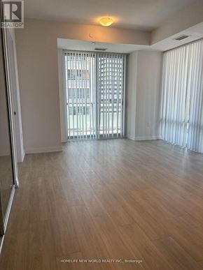 Toronto (Mount Pleasant West) condo for rent - A room with wooden flooring and a sliding glass door.