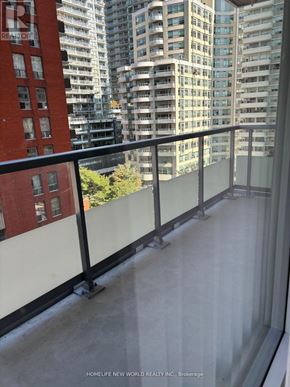 Toronto (Mount Pleasant West) condo for rent - A balcony with a glass railing overlooking a cityscape.