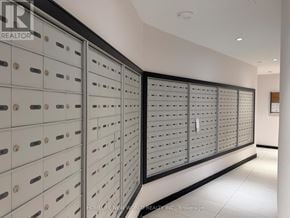 Toronto (Bay Street Corridor) condo for rent - A row of mailboxes are lined up against a wall.