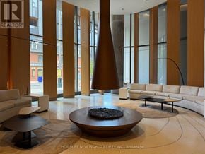 Toronto (Bay Street Corridor) condo for rent - A large, modern living room with a circular coffee table in the center.