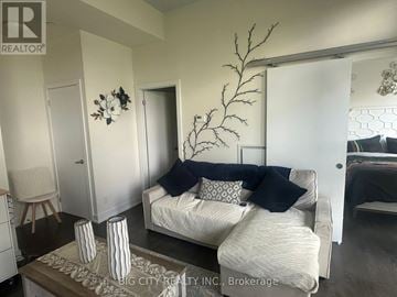 Toronto (Banbury-Don Mills) condo for rent - A living room with a white couch and a decorative plant.