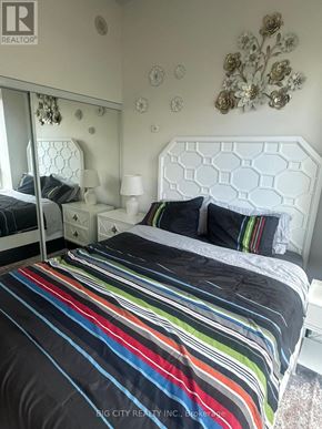 Toronto (Banbury-Don Mills) condo for rent - A bedroom with a white bed and a mirror.