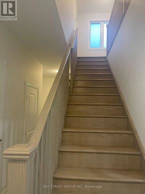 Georgina (Keswick South) apartment for rent - A staircase with wooden steps and white railings.