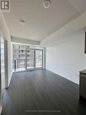 Toronto (Humber Heights) condo for rent - A spacious room with a sliding glass door leading to a balcony.