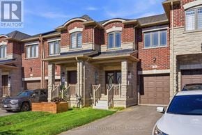 Thorold (Thorold Downtown) townhouse for rent - A row of houses with a car parked in front of them.