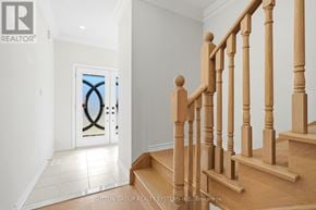 Thorold (Thorold Downtown) townhouse for rent - A wooden staircase with a glass door in the background.