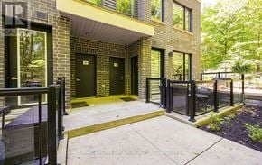 Mississauga (Erin Mills) townhouse for rent - The image shows a modern building with a green door and windows.