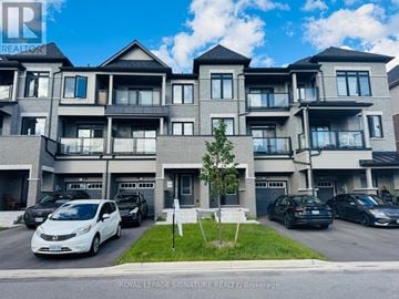 Oshawa (Kedron) townhouse for rent - A white car is parked in front of a Royal LePage Signature Realty Brokerage building.