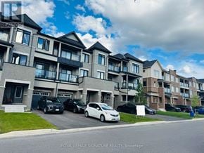 Oshawa (Kedron) townhouse for rent - A white car is parked in front of a building with a sign that says "Royal LePage Signature Realty, Brokerage.".