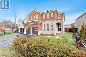 Barrie (Innis-Shore) apartment for rent - A large brick house with a black fence in front.