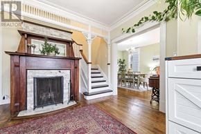 Pembroke apartment for rent - A living room with a fireplace and a dining area in the background.