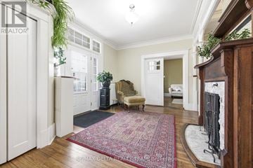 Pembroke apartment for rent - A living room with a red rug and a fireplace.