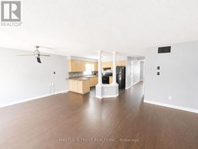 Kitchener apartment for rent - A spacious room with a kitchen area in the background.