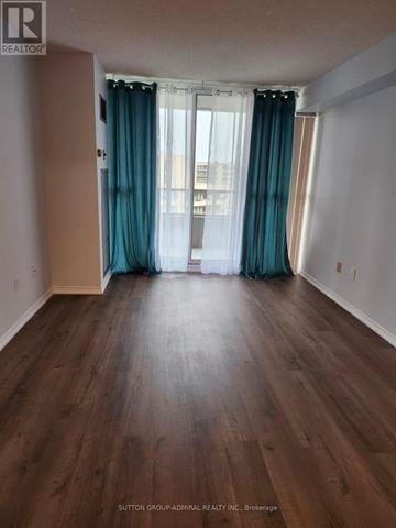 Vaughan (Crestwood-Springfarm-Yorkhill) condo for rent - A room with wooden flooring and a window with blue curtains.