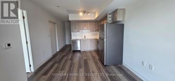 Toronto (Yorkdale-Glen Park) condo for rent - A kitchen with a refrigerator and a countertop.
