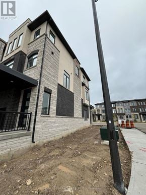 Cambridge townhouse for rent - A building with a grey and black facade is under construction.