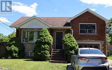 Toronto (Agincourt South-Malvern West) apartment for rent - A house with a car parked in front.
