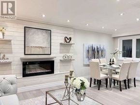 Whitchurch-Stouffville (Stouffville) apartment for rent - A modern living room with a fireplace and a dining table set up.