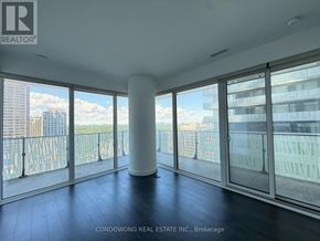 Toronto (Church-Yonge Corridor) condo for rent - A room with a view of the cityscape through large windows.