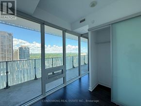 Toronto (Church-Yonge Corridor) condo for rent - A room with a balcony overlooking a cityscape.