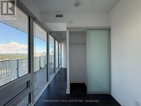 Toronto (Church-Yonge Corridor) condo for rent - A room with a glass door and a balcony with a view of the city.