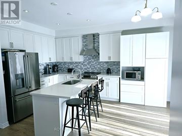 Whitby (Rolling Acres) apartment for rent - A kitchen with white cabinets and a marble backsplash.