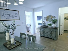 Whitby (Rolling Acres) apartment for rent - A dining room with a table set for two and a sign that says "Welcome Home".