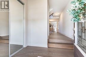 Milton (Bw Bowes) apartment for rent - A hallway with a glass door and a plant on the right side.