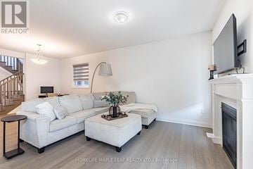 Milton (Bw Bowes) apartment for rent - A living room with a white couch and a television on the wall.
