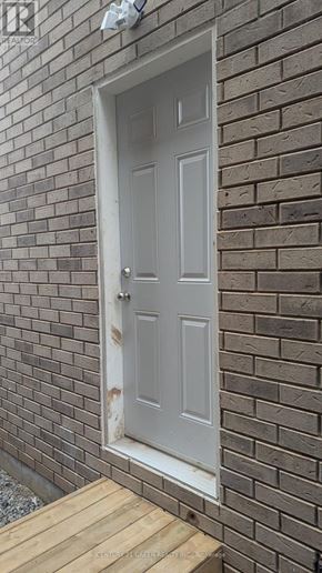 Milton (Bw Bowes) apartment for rent - A white door is on a brick wall.