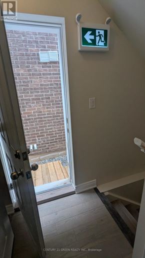 Milton (Bw Bowes) apartment for rent - A green exit sign with a white arrow pointing left.