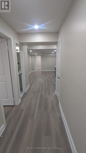 Milton (Bw Bowes) apartment for rent - A long hallway with wood floors and white walls.