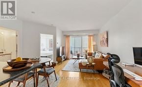 Ottawa condo for rent - A living room with a dining table and chairs, a couch, and a television.
