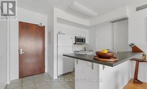 Ottawa condo for rent - A kitchen with a brown door and white cabinets.
