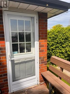 Oshawa (Mclaughlin) apartment for rent - A white door with a glass window is on a brick wall.
