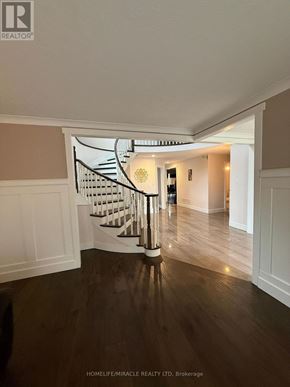 Burlington (Headon) apartment for rent - A spacious hallway with a spiral staircase.