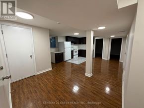 Brampton (Westgate) apartment for rent - A spacious room with wooden flooring and white walls.