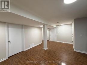 Brampton (Westgate) apartment for rent - A spacious room with wooden flooring and white walls.