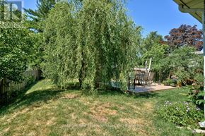 Oakville (Oo Old Oakville) apartment for rent - A backyard with a lawn, a tree, and a patio.
