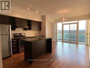 Toronto (Thorncliffe Park) condo for rent - A modern kitchen with wooden floors and a large island.