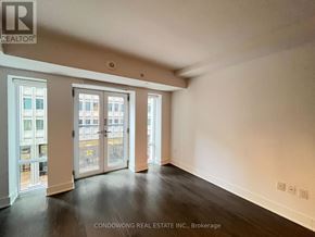 Toronto (Bay Street Corridor) condo for rent - A room with a large window and sliding glass doors.