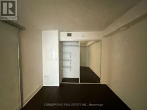 Toronto (Bay Street Corridor) condo for rent - A white door is in a hallway with a sign that says "REALTOR" on the wall.