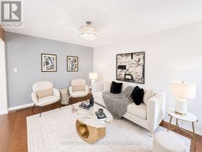 Oshawa (Pinecrest) apartment for rent - A living room with a white couch, two chairs, and a coffee table.