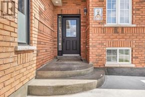 Barrie (Edgehill Drive) apartment for rent - A brick house with a black door and a small statue on the wall.