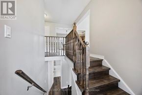 Barrie (Edgehill Drive) apartment for rent - A staircase with a wooden handrail and white walls.