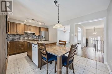 Barrie (Edgehill Drive) apartment for rent - A kitchen with a table and chairs in the middle of the room.