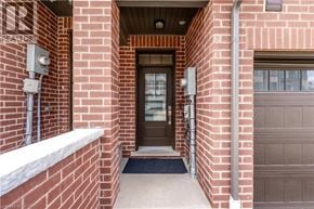 Cambridge townhouse for rent - A brown door is in the middle of a brick wall.